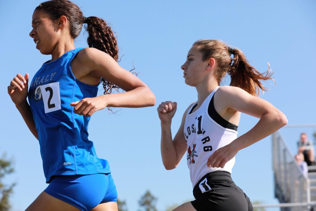 Gabrielle Peterson of Healdsburg High School trails Sierra Atkins of Analy High School midway in the 1,600-meter race during the North Bay League track and field finals at Montgomery High School on Saturday, May 3, 2019. Peterson won the race. (Photo by Darryl Bush / For The Press Democrat)