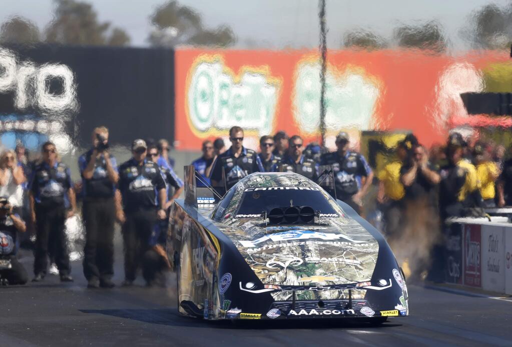 John Force drives a PEAK Chevy Camero SS during a race against Ron Capps, rear, driving a NAPA Auto Parts Dodge Charger R/T in the Funny Car finals during the Toyota HRA Sonoma Nationals at Sonoma Raceway on Sunday, July 31, 2016 in Sonoma, California . (BETH SCHLANKER/ The Press Democrat)