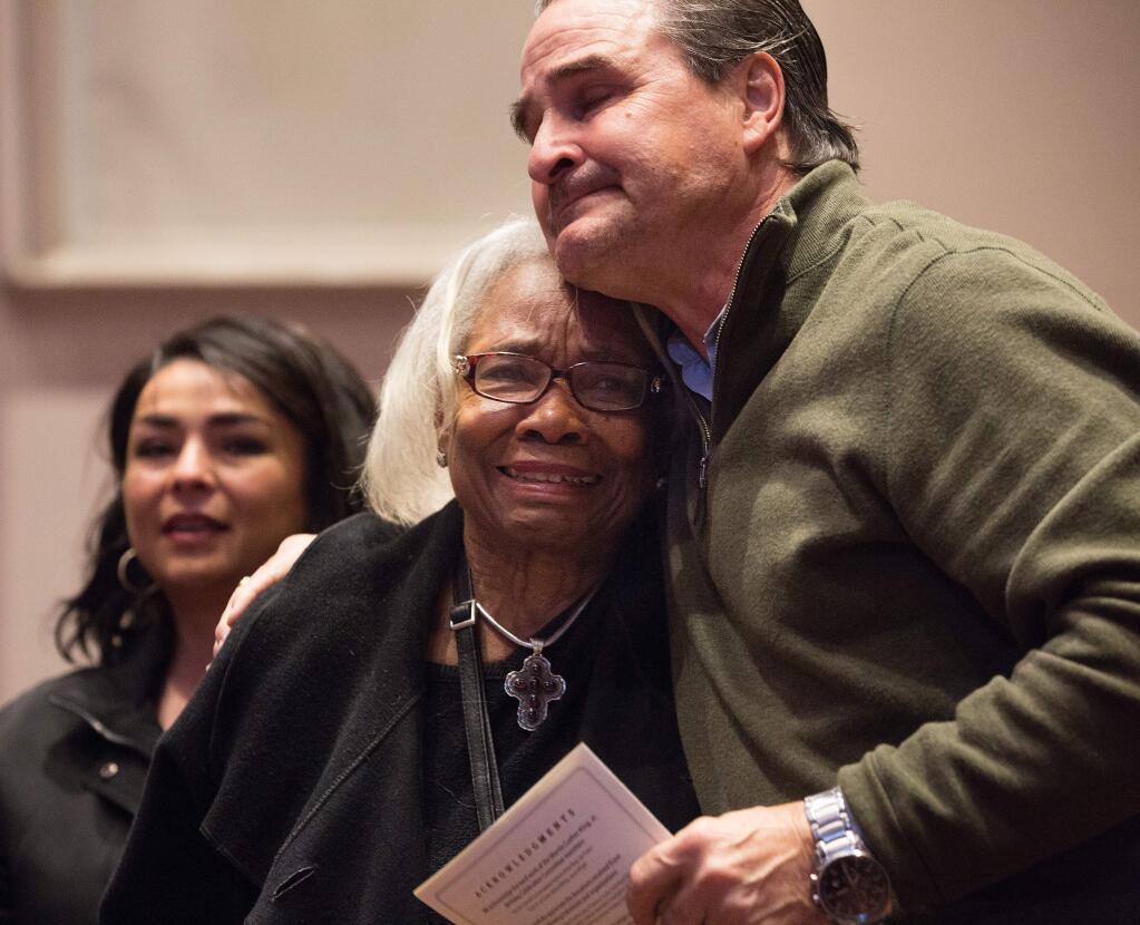Carole Ellis, mother of the late Dyan Foster and Peter Foster, Fosters husband, hug as it is announced that the Martin Luther King, Jr. Annual Birthday Celebration at Santa Rosa High School is dedicated to Dyan Foster, a long-time champion of at-risk youth on Sunday January 15, 2017. ( Photo by Charlie Gesell for the Press Democrat)