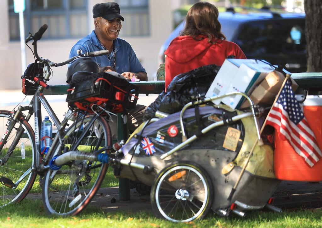Randy Clay, COTS lead outreach specialist, talks with Joseph Pedersen, who lives on the streets and sometimes with friends, Thursday August 24, 2017 at Walnut Park in Petaluma. (Kent Porter / The Press Democrat) 2017
