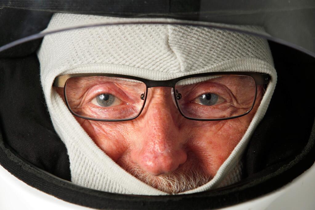 Retired contractor Silas Boden, 76, poses for a portrait wearing his racing helmet at his home in Windsor on Friday, July 20, 2018. Boden continues to live his dream of being a race car driver with his next race at Laguna Seca next weekend. (Alvin Jornada / The Press Democrat)