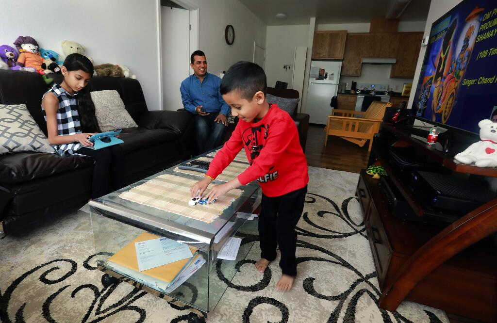Photos by John Burgess / The Press DemocratFrom left, Palak, 10, Pawan, and Kush, 4, Nagpal play in the living room of their home at Fetters Apartments in Sonoma Valley. The Nagpal family were one of 60 families to receive housing out of more than 800 applicants.