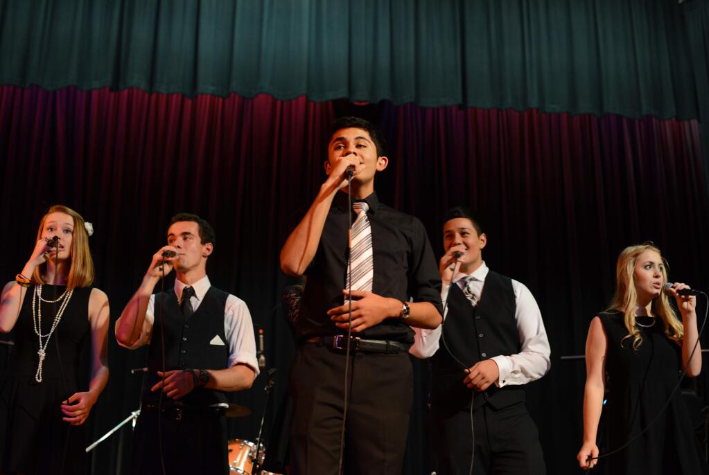 Sandeep Tiwari, center, leads the Maria Carrillo High School Jazz Choir performance at the 5th Annual Night Under the Lights gala held at the Friedman Center in Santa Rosa on Saturday, Oct. 25, 2014. (ERIK CASTRO/ FOR THE PD)