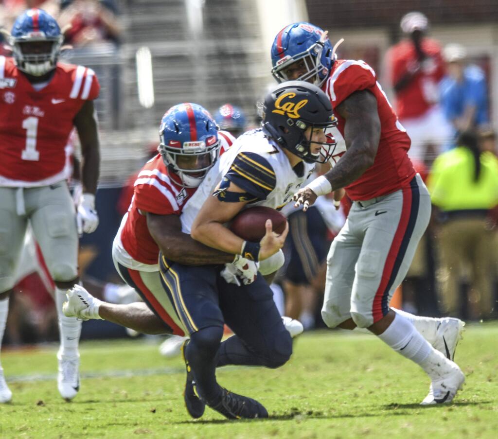 California quarterback Chase Garbers (7) is sacked by Mississippi defensive back Myles Hartsfield (15) and Mississippi linebacker Charles Wiley (99) at Vaught-Hemingway Stadium in Oxford, Miss. on Saturday, September 21, 2019. California won 28-20. (Bruce Newman/Oxford Eagle via AP)