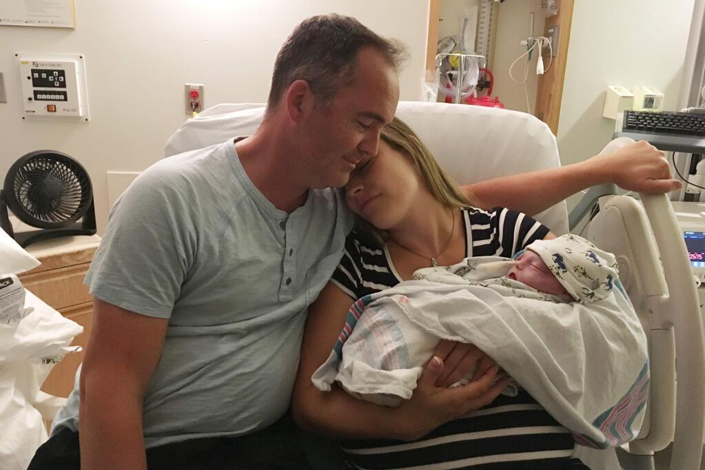 This July 29, 2017 photo provided by Megan Breau shows Rebekah Shirey and her partner, Steve Martin, with their stillborn chid, Elijah, in an Ottawa, Canada hospital. Shirey had learned days earlier that Elijahâs heart had stopped beating. âThe more awareness we have and the more community we have makes it easier to go through these things,â she says. (Megan Breau via AP)