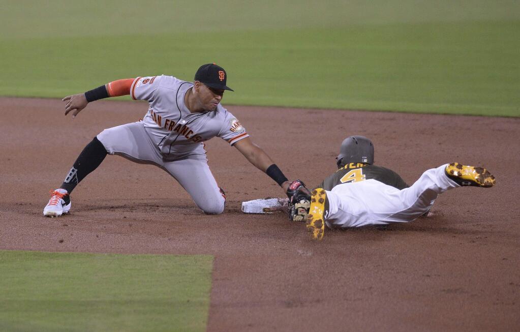 The San Diego Padres' Wil Myers steals second base ahead of the tag by San Francisco Giants second baseman Yangervis Solarte during the first inning, Friday, March 29, 2019, in San Diego. (AP Photo/Orlando Ramirez)