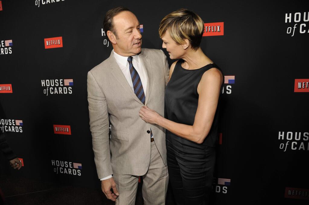 FILE - In this Feb. 13, 2014, file photo, Kevin Spacey, left, and Robin Wright arrive at a special screening for season 2 of 'House of Cards' in Los Angeles. The Huffington Post reported that Wright said during an interview at the Rockefeller Foundation on Tuesday, May 17, 2016, that she demanded the same pay as co--star Kevin Spacey for her work on Netflix's 'House of Cards.' (Photo by Chris Pizzello/Invision/AP, File)