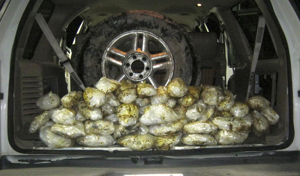 In this Tuesday, Oct. 1, 2019, photo provided by U.S. Border Patrol San Diego, bags of methamphetamine are hidden inside an SUV that was intercepted at the Interstate 8 checkpoint near San Diego. Border patrol agents have arrested a woman they say tried to smuggle nearly 70 pounds of methamphetamine through a Southern California checkpoint with her 6-year-old son in the car. Authorities say the woman, a 25-year-old Mexican citizen, was stopped at the Pine Valley checkpoint in San Diego County Tuesday night. (U.S. Border Patrol San Diego via AP)