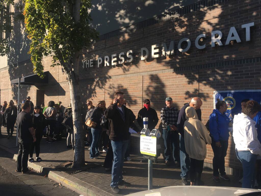 People seeking information and access to services lined up on Mendocino Avenue before 9 a.m. at a newly established FEMA hub, Saturday, Oct. 14, 2017. (Nick Rahaim / Press Democrat)