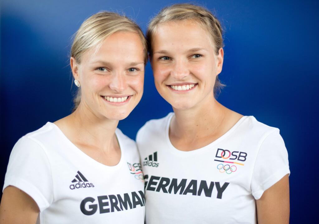 FILE - In this July 7, 2016 file picture Anna, left, and Lisa Hahner pose for pictures in Hannover, Germany. A German marathon runner who was criticized for holding hands with her twin sister as they crossed the finishing line at the Olympics in Rio has been awarded a belated first place for a race in her home country. Organizers of the Hannover marathon on Thursday Aug. 18, 2016 declared Anna Hahner the winner of the April event after Kenias Edinah Jerotich Kwambai was penalized for using an excessive dose of asthma medication. ( Julian Stratenschulte/dpa via AP,file)