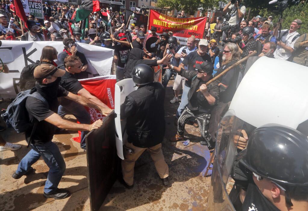 White nationalist demonstrators clash with counter demonstrators Aug. 12 in Charlottesville, Virginia. (STEVE HELBER / Associated Press)