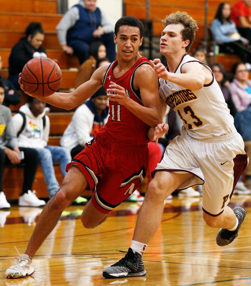 Montgomery's Devin Ramirez, left, drives to the basket while guarded by Piner's Jett Walker during the first half in Santa Rosa on Tuesday, January 7, 2020. (Alvin Jornada / The Press Democrat)