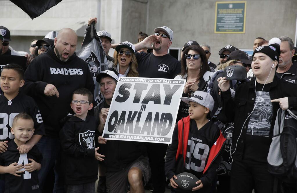 Oakland Raiders fans gather for a picture before the start of a rally to keep the team from moving Saturday, March 25, 2017, in Oakland. (AP Photo/Eric Risberg)
