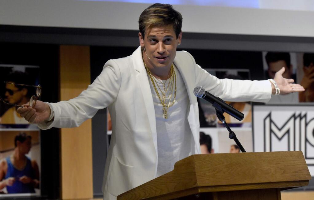 FILE - In this Jan. 25, 2017 file photo, Milo Yiannopoulos speaks on campus in the Mathematics building at the University of Colorado in Boulder, Colo. Yiannopoulos, the polarizing Breitbart News editor, has gained notoriety for railing against feminists, Muslims and political correctness. The next stop on his college speaking tour is UC Berkeley, where protests and outrage against the event have stirred a debate about freedom of speech and highlighted the sensitivities on college campuses at the dawn of the Trump presidency. (Jeremy Papasso/Daily Camera via AP, file)
