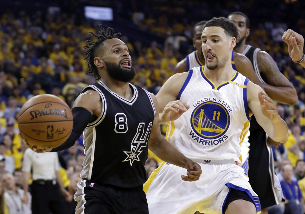 San Antonio Spurs' Patty Mills (8) is defended by Golden State Warriors' Klay Thompson (11) during the second half of Game 2 of the Western Conference finals, Tuesday, May 16, 2017, in Oakland. (AP Photo/Marcio Jose Sanchez)
