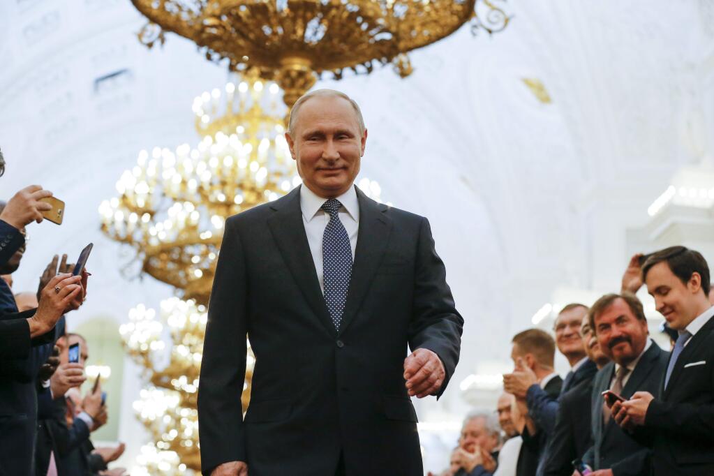 Vladimir Putin enters to take the oath during his inauguration ceremony for a new term as Russia's president in the Grand Kremlin Palace in Moscow, Russia, Monday, May 7, 2018. Putin took the oath of office for his fourth term as Russian president on Monday and promised to pursue an economic agenda that would boost living standards across the country. (AP Photo/Alexander Zemlianichenko, Pool)