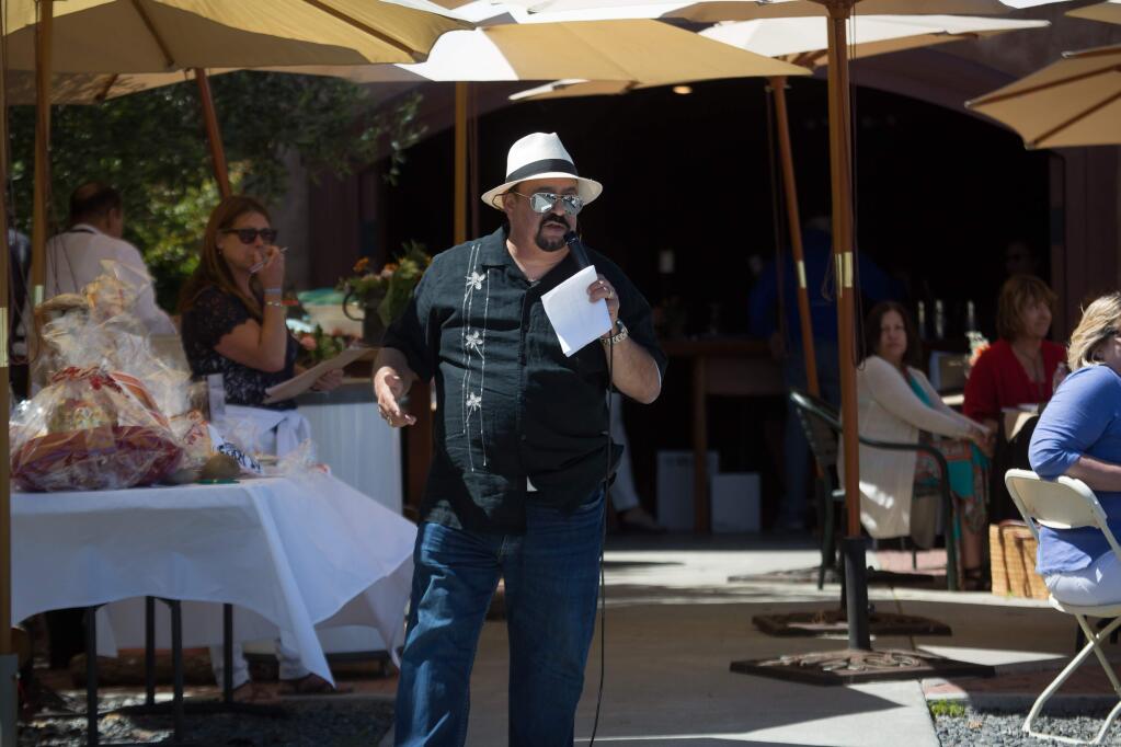 Mark Molina, of the Petaluma Shakespeare Company leads a live auction during Shakespeare in the Vineyard at Azari Vineyards in Petaluma, Calif. Sunday, June 11, 2017. (Jeremy Portje / For The Press Democrat)