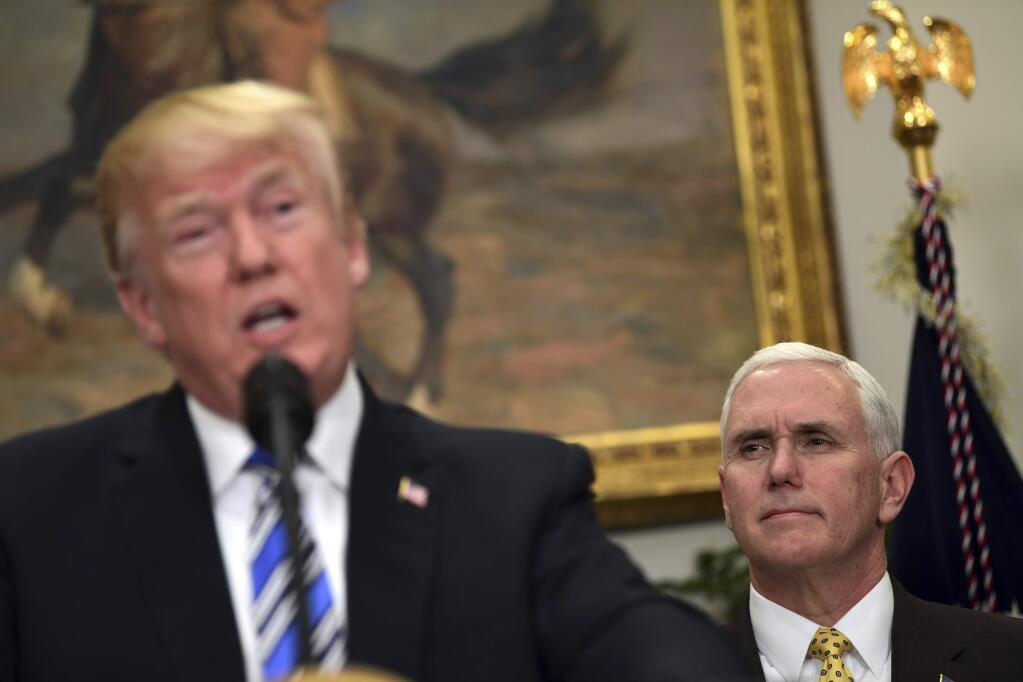 Vice President Mike Pence, right, listens as President Donald Trump speaks in the Roosevelt Room at the White House in Washington, Thursday, March 8, 2018, during an event where Trump signed two proclamations, one on steel imports and the other on aluminum imports. (AP Photo/Susan Walsh)