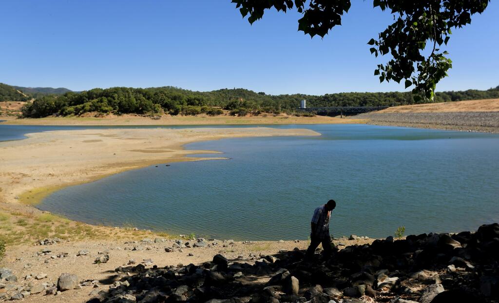 In June, Travis Parsons of Ukiah walked around the receding shoreline of Lake Mendocino, the county's main reservoir (Kent Porter/Press Democrat)
