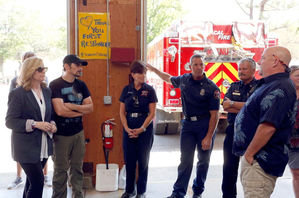 Actress Bonnie Hunt, far left, and country music singer-songwriter Brad Paisley visit local firefighters at the Cal Fire station in Glen Ellen, California, on Saturday, August 4, 2018. (Alvin Jornada / The Press Democrat)