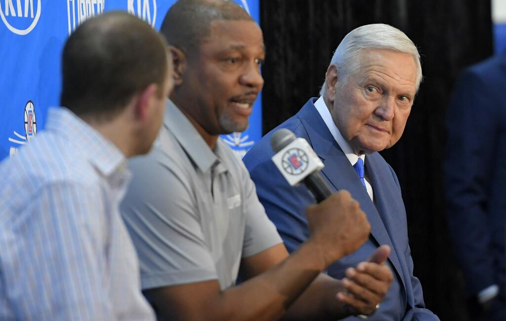 Los Angeles Clippers president of basketball operations and head coach Doc Rivers, center, speaks as Jerry West, right, listens along with Clippers executive vice president of basketball operations Lawrence Frank during a news conference to introduce West as an advisor to the Los Angeles Clippers, Monday, June 19, 2017, in Los Angeles. (AP Photo/Mark J. Terrill)