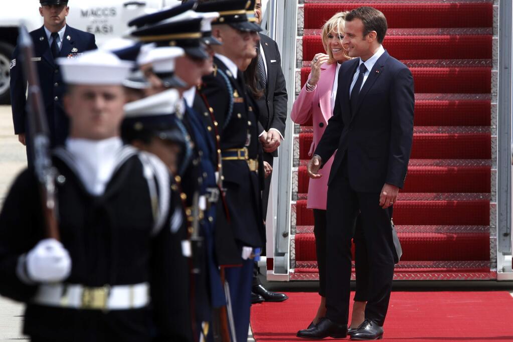 French President Emmanuel Macron and Brigitte Macron smile as they greet people on the red carpet as they arrive at Andrews Air Force Base, Md., Monday April 23, 2018, outside of Washington. President Donald Trump, celebrating nearly 250 years of U.S.-French relations, will be hosting Macron at a glitzy White House state visit. (AP Photo/Jacquelyn Martin)