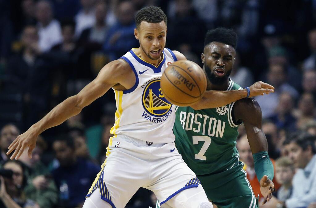 The Boston Celtics' Jaylen Brown, right, and the Golden State Warriors' Stephen Curry, left, battle for a loose ball during the first quarter in Boston, Thursday, Nov. 16, 2017. (AP Photo/Michael Dwyer)