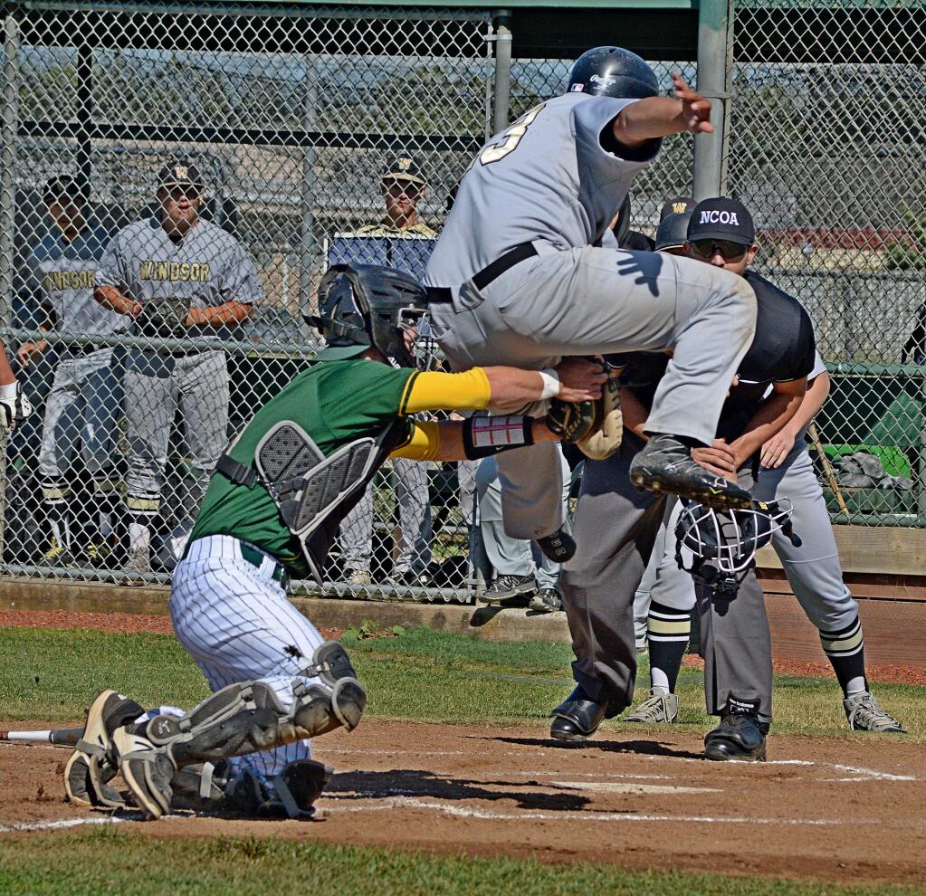 SUMNER FOWLER/FOR THE ARGUS-COURIERCasa Grande's John Green tags out Windsor's Joe Pignataro as the runner attempts to leap over the catcher during Casa's 8-1 win.