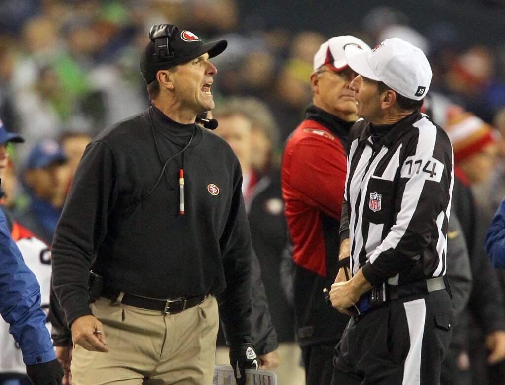 Nothing unusual about this scene: Jim Harbaugh giving an earful to an official. This scene played out in the NFC championship game in Seattle on Jan. 19, 2014. (John Burgess / The Press Democrat)