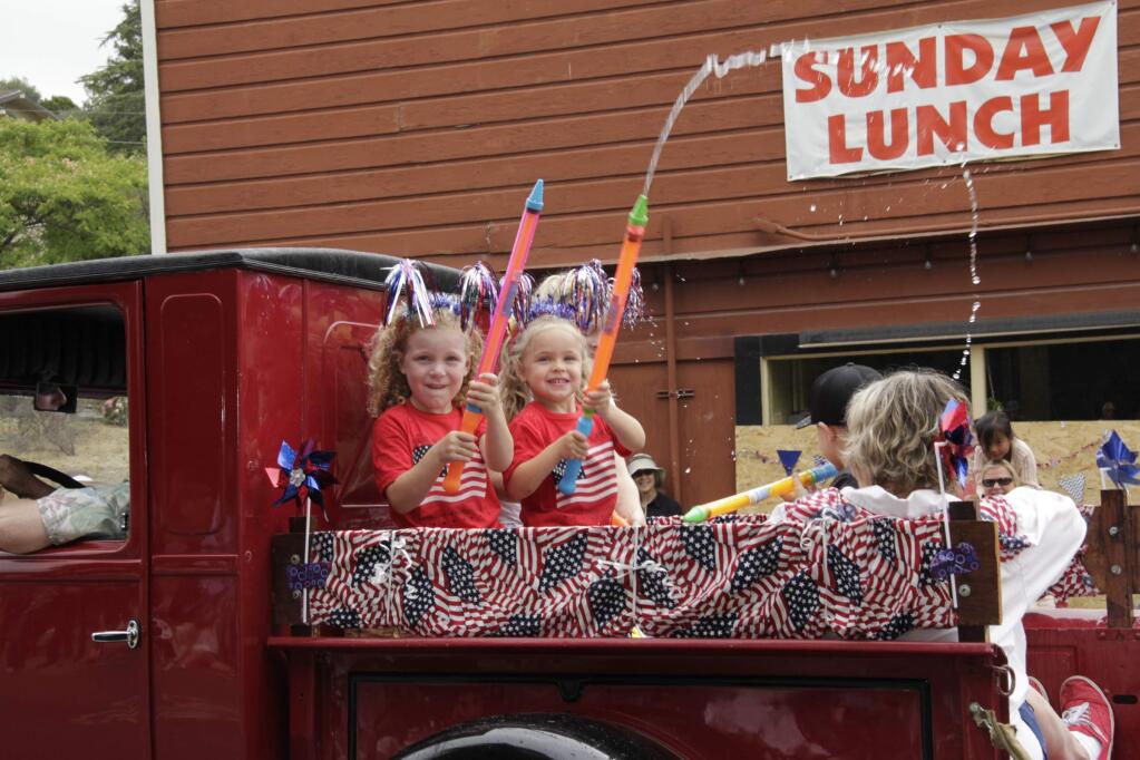 These kids go after the photographer with their water guns. The 39th Annual Penngrove Celebration Parade was held on July 5 2015 in Penngrove CA. (Jim Johnson/For the Argus-Courier)