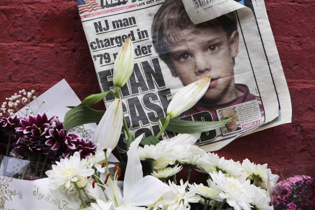 FILE - This May 28, 2012, file photo shows a newspaper with a photograph of Etan Patz at a makeshift memorial in the SoHo neighborhood of New York where Patz lived before his disappearance on May 25, 1979. The memorial was set up near a building that housed a convenience store where Pedro Hernandez, accused of killing Patz, told police 33 years after they boy's disappearance, that he choked the 6-year-old and put the still-living boy into a plastic bag, boxed up the bag and left it on a street. Opening statements in Hernandez's trial are set for Friday, Jan. 30, 2015. (AP Photo/Mark Lennihan, File)