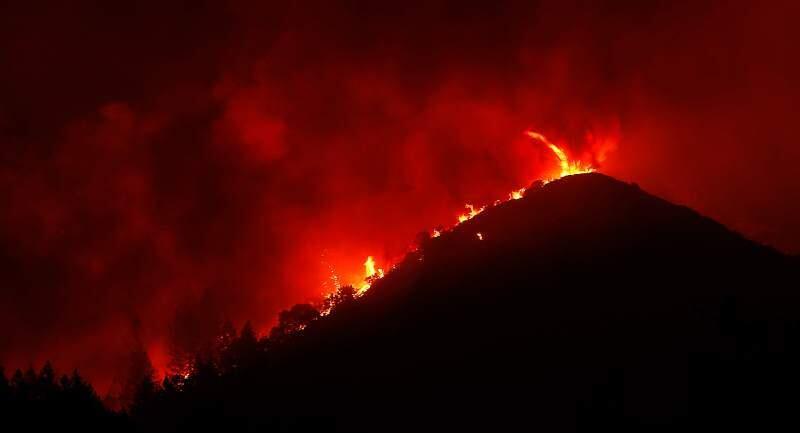 A fire dances along a ridge line near Pythian Road as the Nuns fire burns near Santa Rosa, California on Monday, Oct. 16, 2017. (ALVIN JORNADA/ PD)