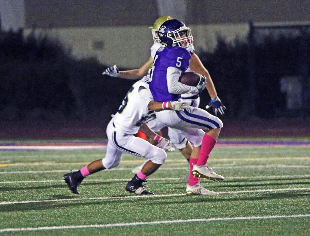 DWIGHT SUGIOKA/FOR THE ARGUS-COURIERGarrett Freitas strugles for extra yards against Napa. The senior rushed for 157 yards in his team's 41-22 win.