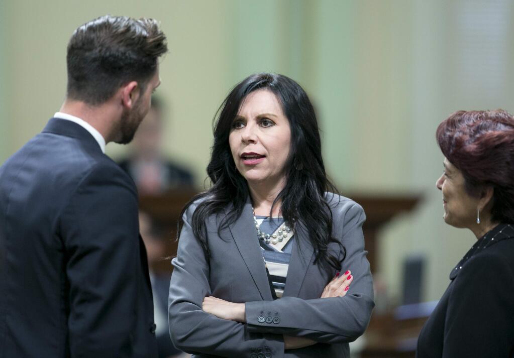 FILE -- In this July 17, 2017 file photo Assemblywoman Blanca Rubio, D-Baldwin Park, center, talks with Democratic Assembly members Ian Calderon, of Whittier, left, and Anna Caballero, of Salinas, at the Capitol, in Sacramento, Calif. Rubio, who voted for the recent cap-and-trade bill approved by lawmakers, received more than $14,800 in campaign donations from the oil industry during the first half of 2017. (AP Photo/Rich Pedroncelli, file)