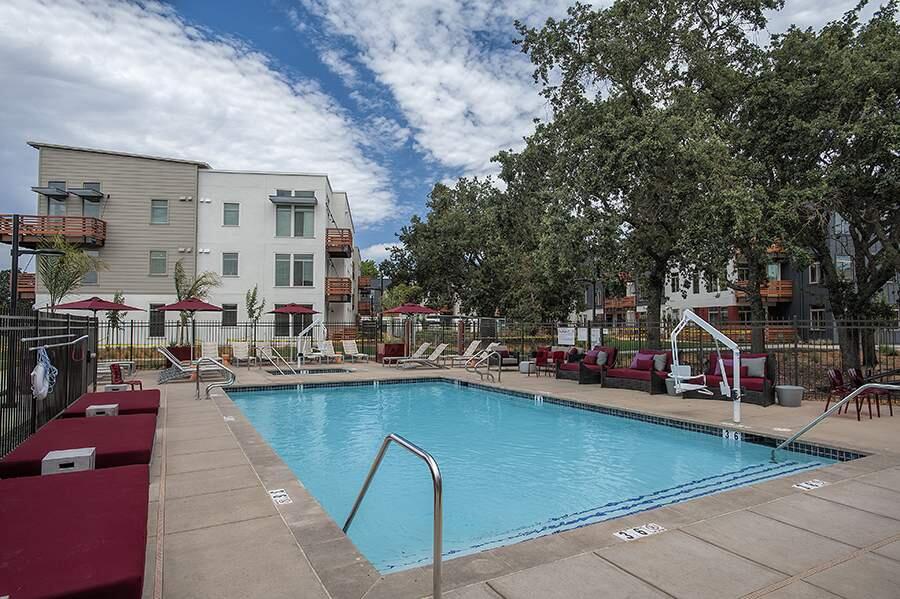 The pool and deck area at The Annadel Apartments in Santa Rosa features a special lift (at right) for those physically challenged enabling them to enjoy the water. Mature trees were preserved along streets in this 390-unit garden-style community.
