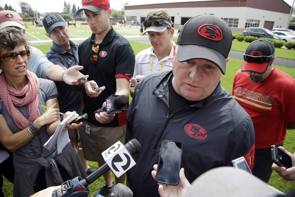 49ers coach Chip Kelly answers questions at practice. (Marcio Jose Sanchez / Associated Press)