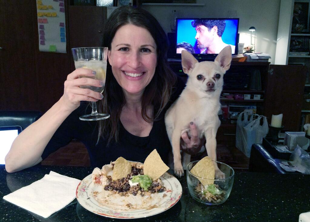 In this May 5, 2014 photo provided by Dana Humphrey, Joanie Pelzer poses with her dog Hubbell, a 9-year-old Chihuahua, in New York. When Pelzer signed up with a dog-friendly online dating service a few years ago, she was honest about her Chihuahua: He likes people more than other dogs, craves attention, steals food and can't stand to ride in the backseat of a car. Even with a man who loved animals as much as she did, he couldnt keep up with her dogs quirks. On their first date, Hubbell stole the mans breakfast as they drove from New York City to Long Island. They only had one more date. (AP Photo/Dana Humphrey)