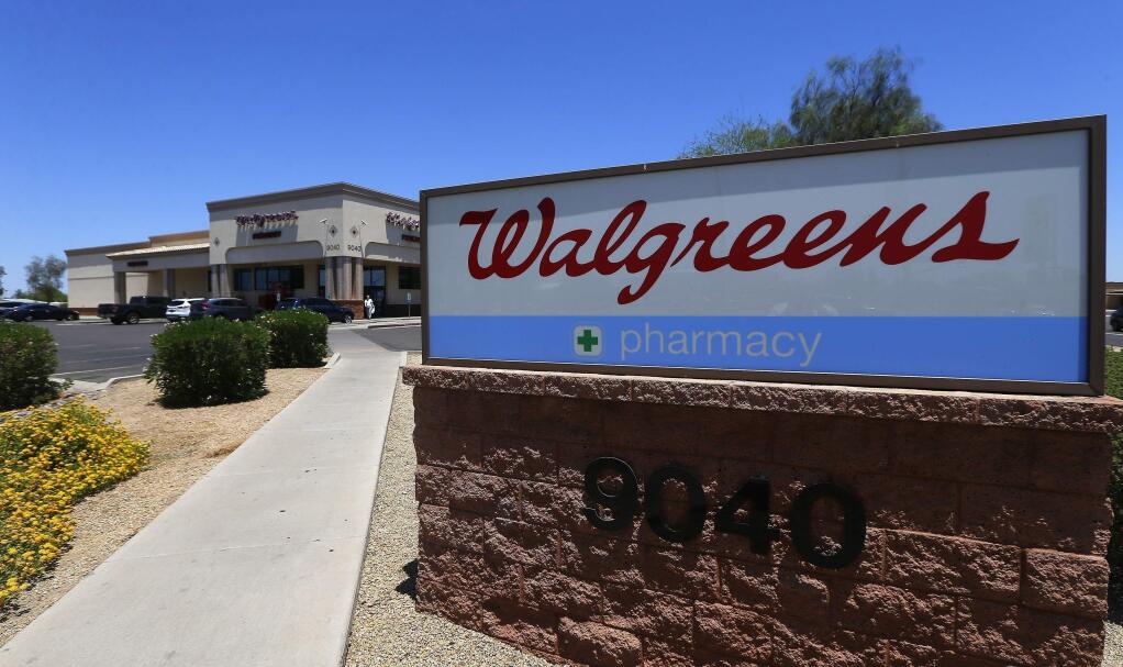 FILE - This June 25, 2018 file photo shows Walgreens in Peoria, Ariz. The drugstore chain is working with Microsoft to improve care, as more companies seek ways to manage patient health, cut costs and improve quality. The companies said Tuesday, Jan. 15, 2019 that they will work to improve care in part by using patient information and the Walgreens store network. (AP Photo/Ross D. Franklin, File)