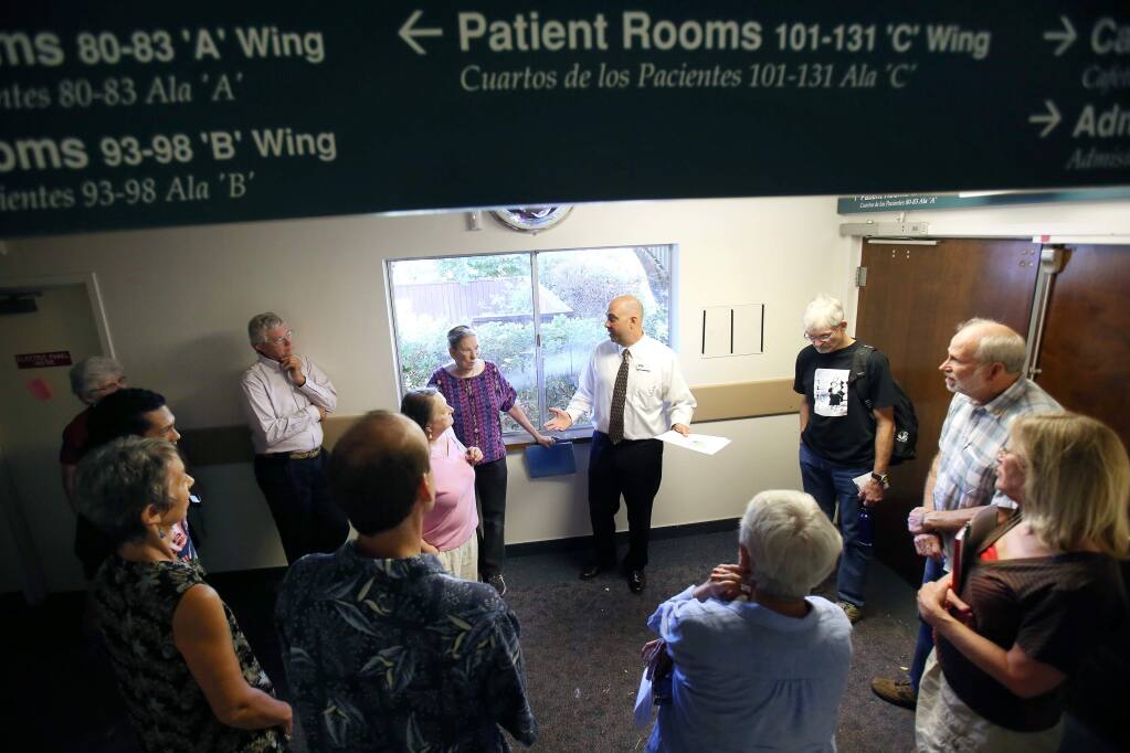 Social Advocates for Youth board president John Meislahn, center, takes community leaders and residents from Bennett Valley through a tour of the old Warrick Hospital in 2013. (PD FILE)
