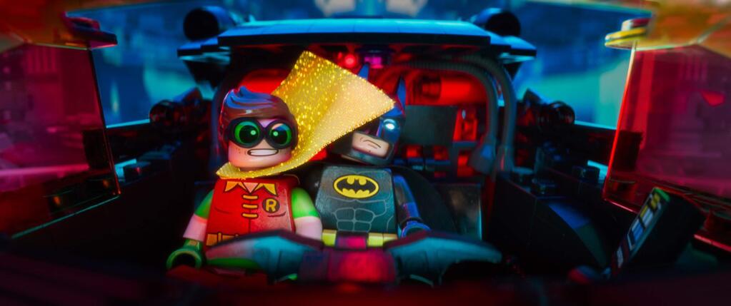 Warner Bros. PicturesRobin (voice of Michael Cera) and Batman (Will Arnett) try to prevent the hostile takeover of the city by the Joker in 'The Lego Batman Movie.'
