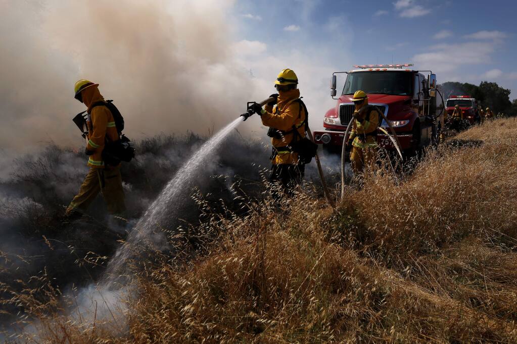 Recruit firefighters of Class 19-1 conduct mobile attack training with live fire during the Sonoma County Fire District recruit firefighter academy, in Windsor on Thursday, June 20, 2019. (Alvin Jornada / The Press Democrat)