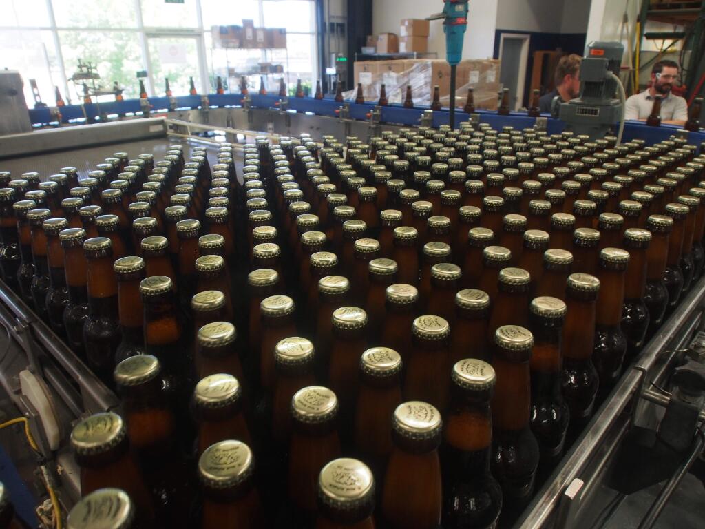 Bottles roll off the bottling line at Bear Republic Brewing's Cloverdale facility on Wednesday, July 3, 2019. (Chase DiFeliciantonio / North Bay Business Journal)