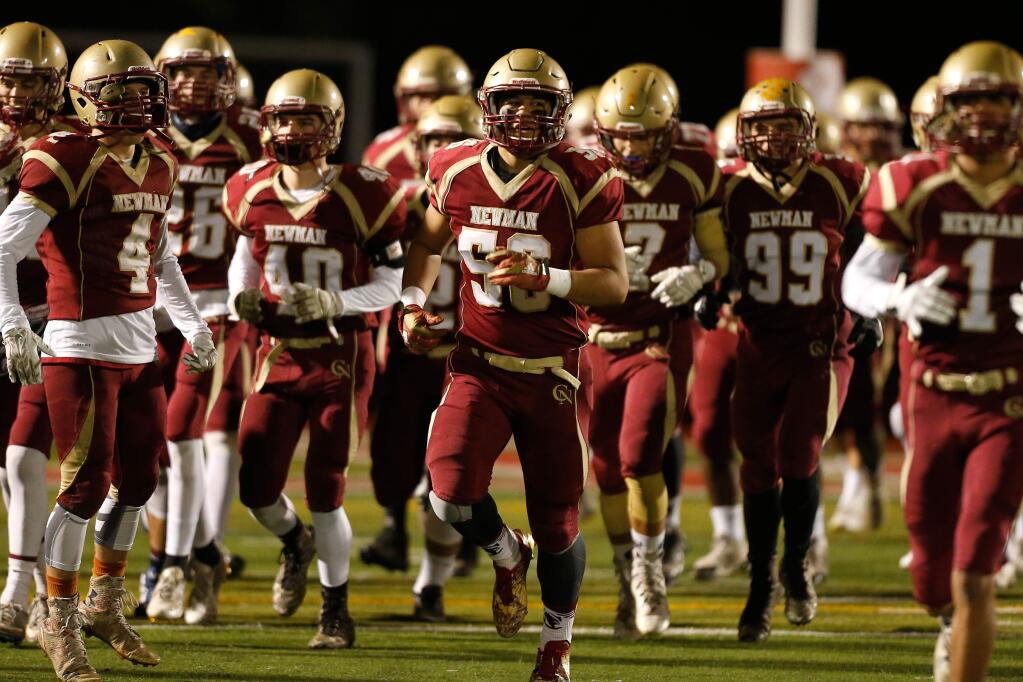 Cardinal Newman's Dino Kahaulelio (56), center and the rest of the Cardinals take the field before the first half of the NCS Division 4 championship football game between Cardinal Newman and St. Bernard's high schools, in Rohnert Park on Saturday, December 3, 2016. (Alvin Jornada / The Press Democrat)