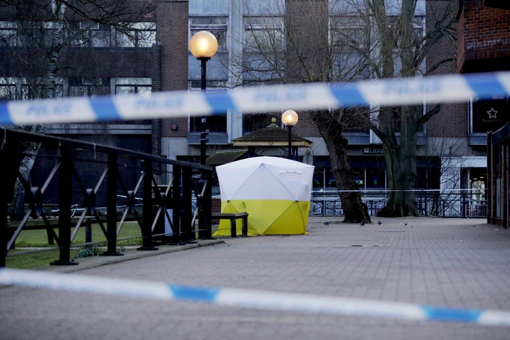 A police tent is framed by police tape covering the the spot where former Russian double agent Sergei Skripal and his daughter were found critically ill Sunday following exposure to an 'unknown substance' in Salisbury, England, Wednesday, March 7, 2018. Britain's counterterrorism police took over an investigation Tuesday into the mysterious collapse of the former spy and his daughter, now fighting for their lives. The government pledged a 'robust' response if suspicions of Russian state involvement are proven. Sergei Skripal and his daughter are in a critical condition after collapsing in the English city of Salisbury on Sunday. (AP Photo/Matt Dunham)