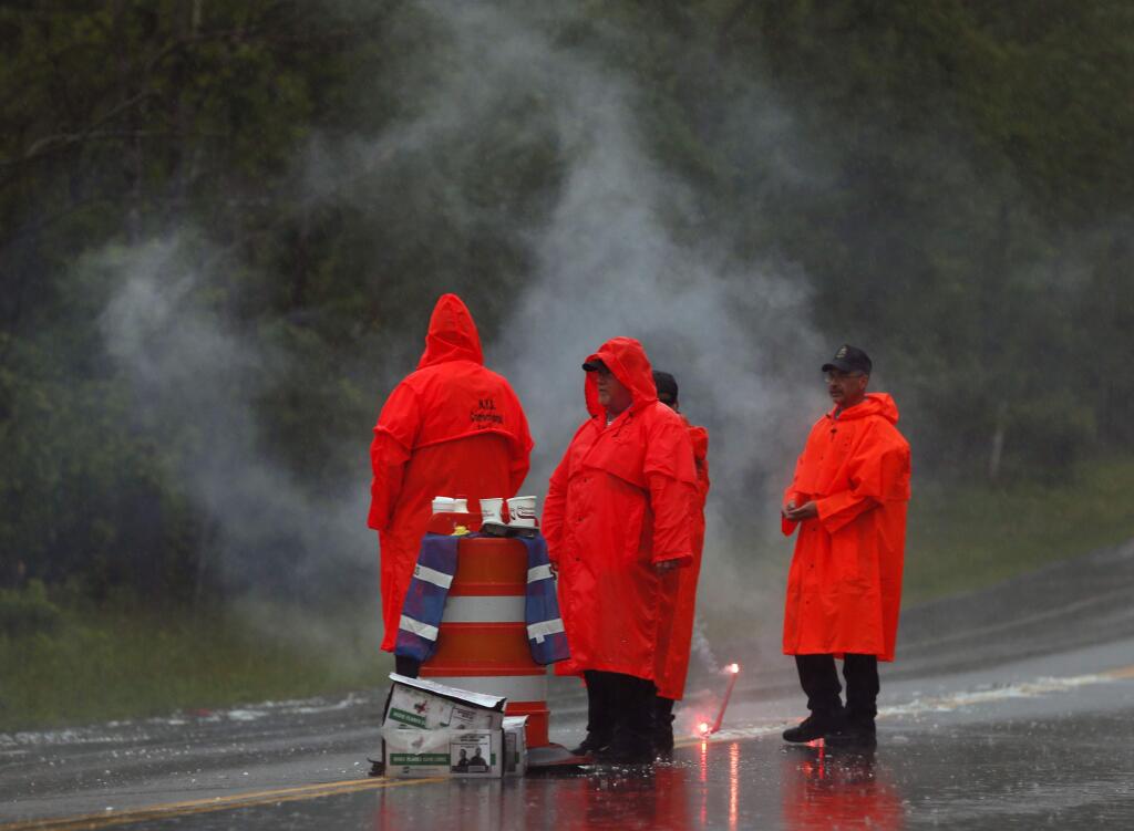 Corrections officers work at a roadblock on Sunday, June 28, 2015, in Malone, N.Y. The shooting death of one escaped killer brought new energy to the three-week hunt for a second escaped murderer in the United States as helicopters, search dogs and hundreds of law enforcement officers converged on a wooded area 30 miles from Clinton Correctional Facility. (AP Photo/Mike Groll)