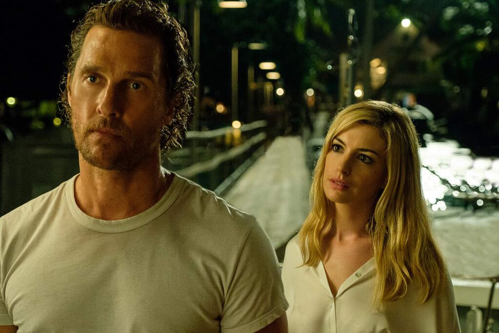 In the thriller 'Serenity,' Baker Dill (Matthew McConaughey, left) is a fishing boat captain leading tours off a tranquil, tropical enclave called Plymouth Island. His quiet life is shattered, however, when his ex-wife Karen (Anne Hathaway, right) tracks him down with a desperate plea for help. She begs Dill to save her - and their young son - from her new, violent husband (Jason Clarke) by taking him out to sea on a fishing excursion, only to throw him to the sharks and leave him for dead. (Avrion Pictures)