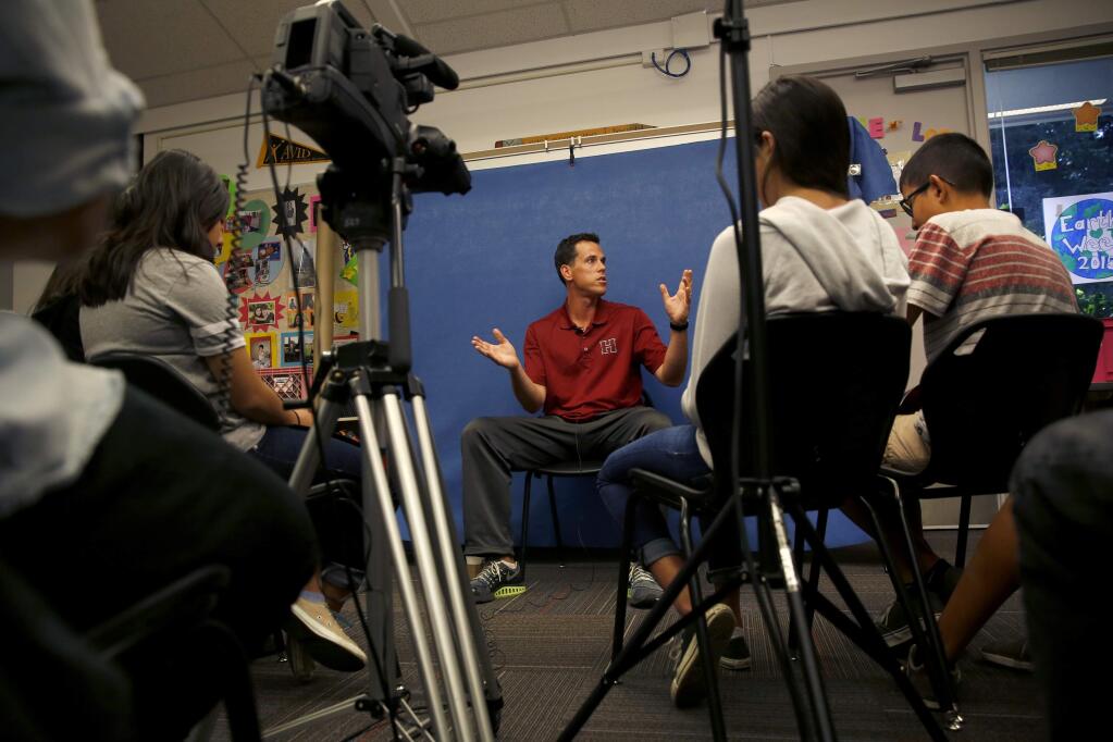 Healdsburg Junior High School physical education teacher answers questions from students in the AVID class at Healdsburg Junior High School as they record his interview as part of the Listening for a Change program. Photo taken at the school in Healdsburg, on Thursday, May 7, 2015. (BETH SCHLANKER/ The Press Democrat)