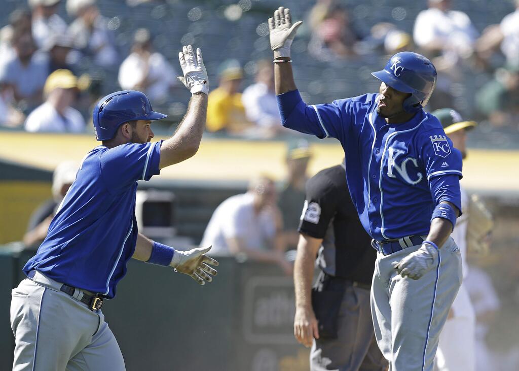The Kansas City Royals' Alcides Escobar, right, celebrates with Drew Butera after scoring against the Oakland Athletics during the ninth inning Wednesday, Aug. 16, 2017, in Oakland. (AP Photo/Ben Margot)