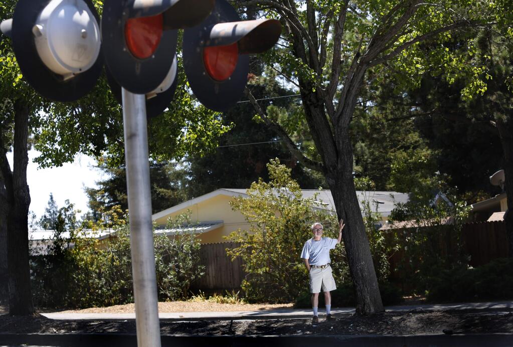 Bob Ulmer, whose home is behind him, stands in the median of North McDowell Blvd just south of Corona Rd near the SMART crossing in Petaluma, on Wednesday, August 3, 2016. (BETH SCHLANKER/ The Press Democrat)