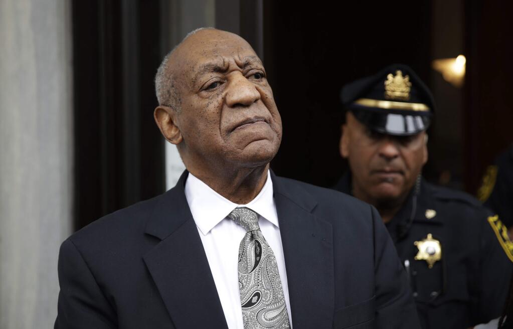FILE - In this Saturday, June 17, 2017, file photo, Bill Cosby exits the Montgomery County Courthouse after a mistrial was declared in his sexual assault trial in Norristown, Pa. Judge Steven O'Neill who presided over Cosby's sexual assault trial is weighing whether to make public the identities of the jurors who deadlocked in the case. He said he would rule by Wednesday, June 21. (AP Photo/Matt Rourke)